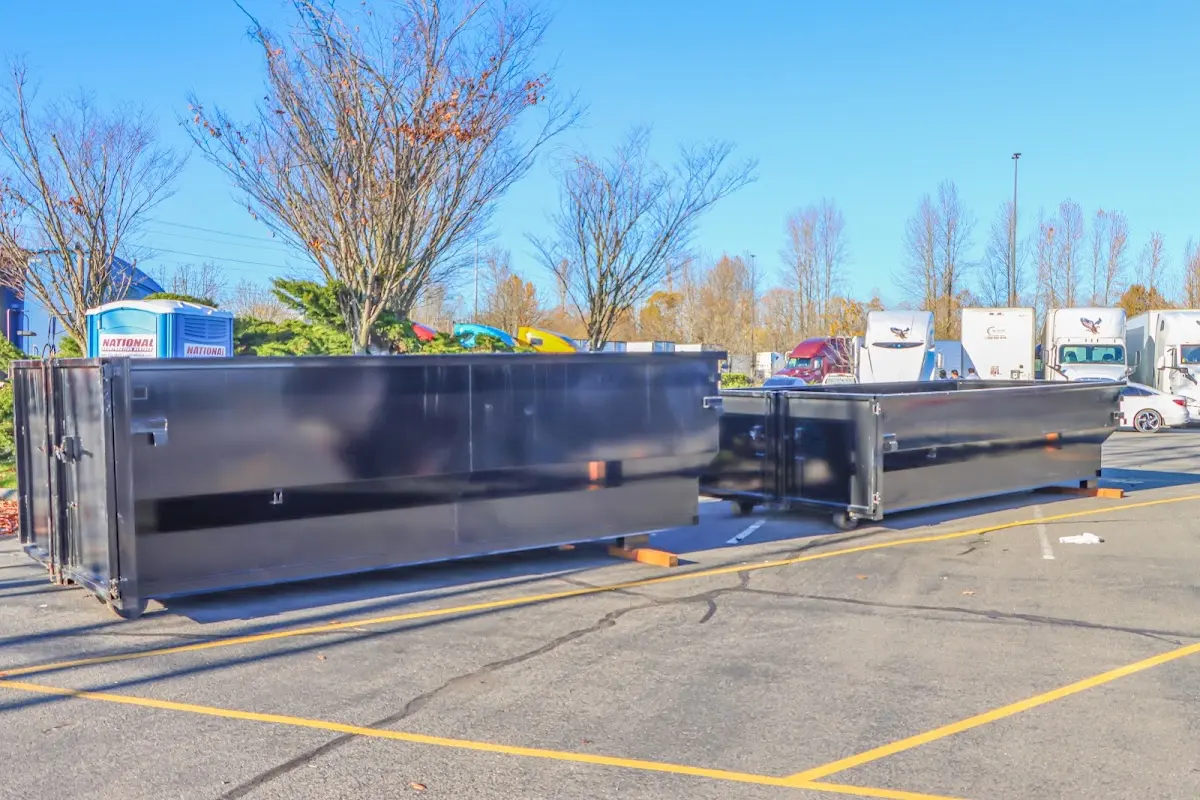Professional dumpster rental service with roll-off container on residential driveway in Cottleville